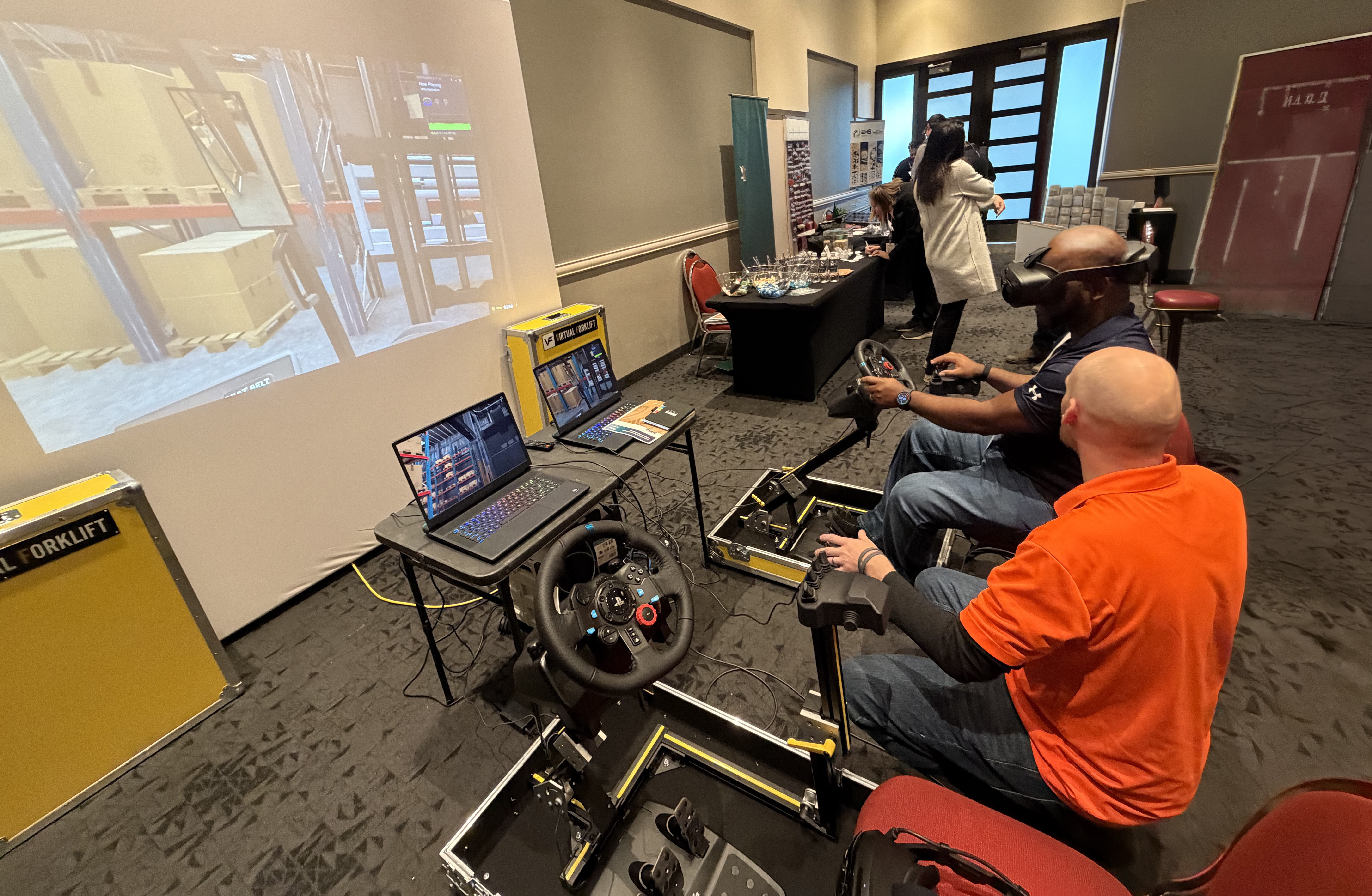 Fold N Go stations set up beside a projector screen at a trade show